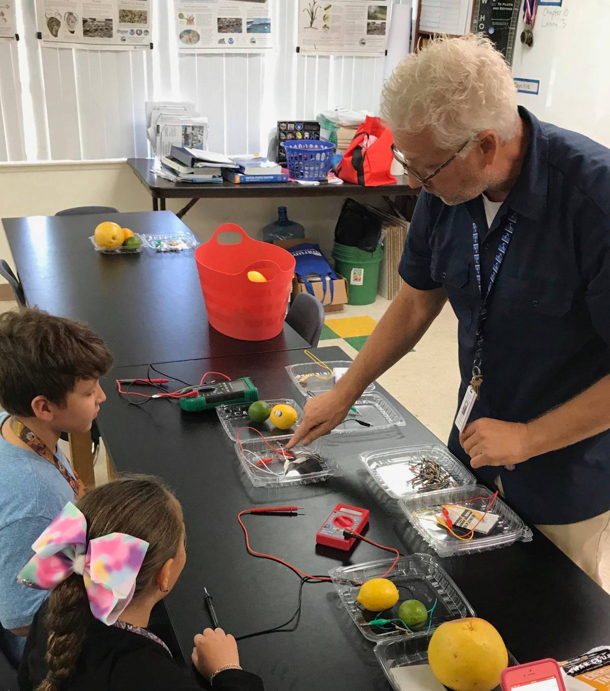 teacher working with students in a science class at Palm Beach Maritime Academy tuition-free K-12 charter school
