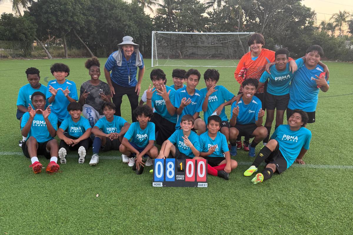 soccer team of students at PBMA tuition-free charter school celebrating a win on the field